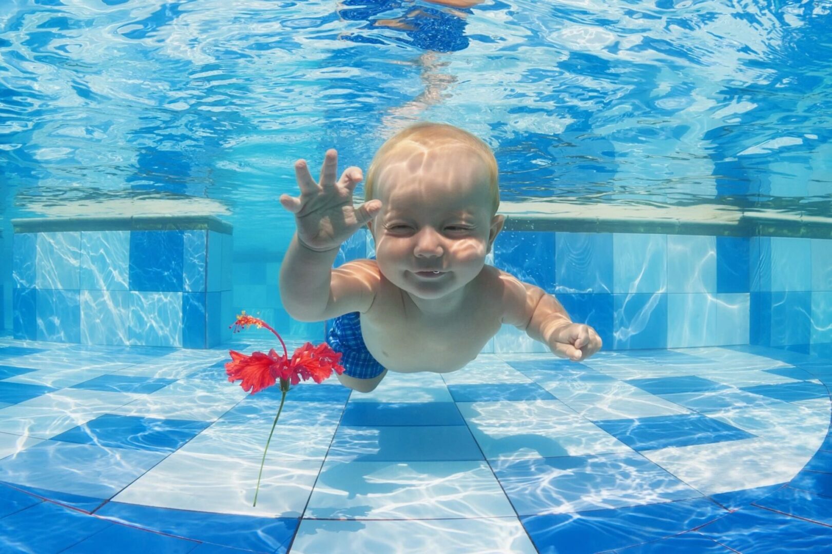 A baby is swimming in the pool